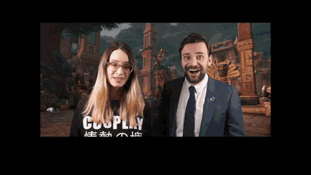 a man and a woman are standing next to each other and the man is wearing a shirt that says cosplay