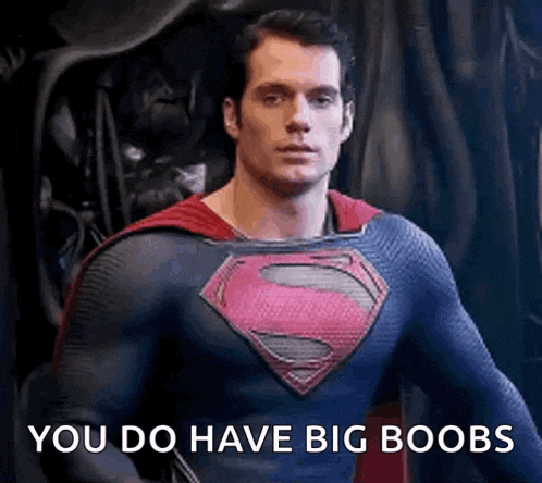 a man in a superman costume with the words `` you do have big boobs '' written on it .