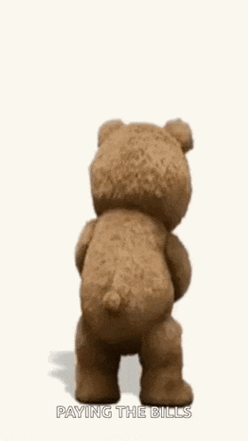 a teddy bear from the movie ted is holding a book and a glass of wine .