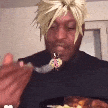 a man is eating a spoonful of food with a picture of a cartoon character on his face .
