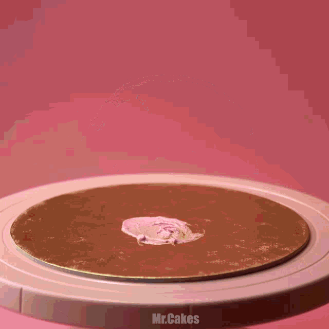 a person is holding a piece of cake on a plate with the words mr.cakes below it