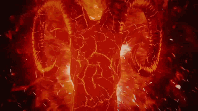 a statue of a demon with horns is surrounded by flames and fire .