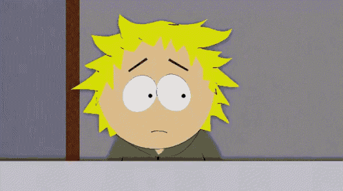 a cartoon character with yellow hair and white eyes has a sad look on his face