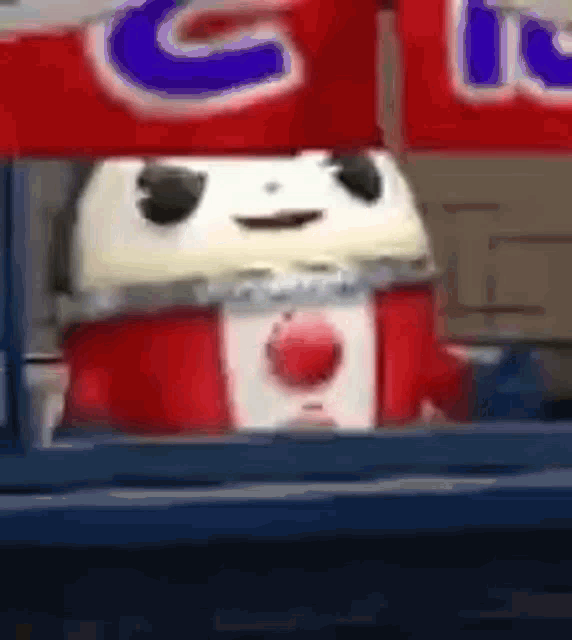 a close up of a cartoon character wearing a canadian flag and a red and white scarf .