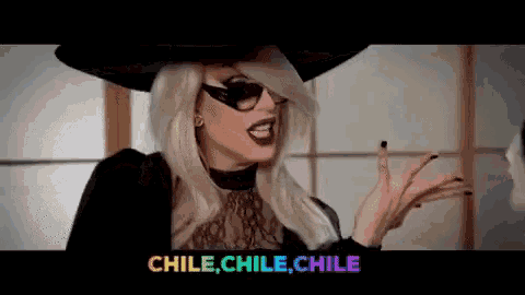 a pixelated image of a woman wearing a hat and sunglasses with the words chile chile chile below her
