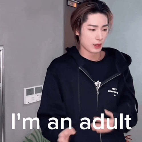 a young man wearing a black hoodie says " i 'm an adult "