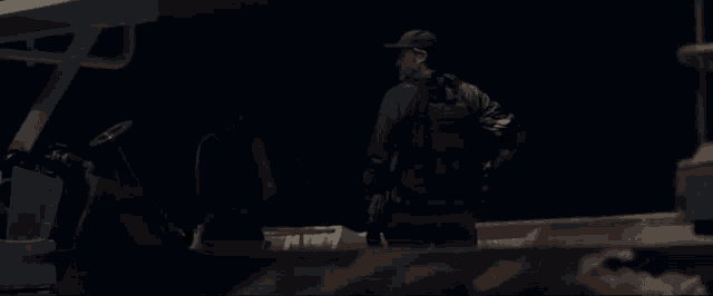 captain america is holding a shield with a star on it in the dark .