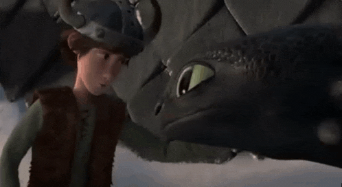 a close up of a toothless from how to train your dragon looking at someone .