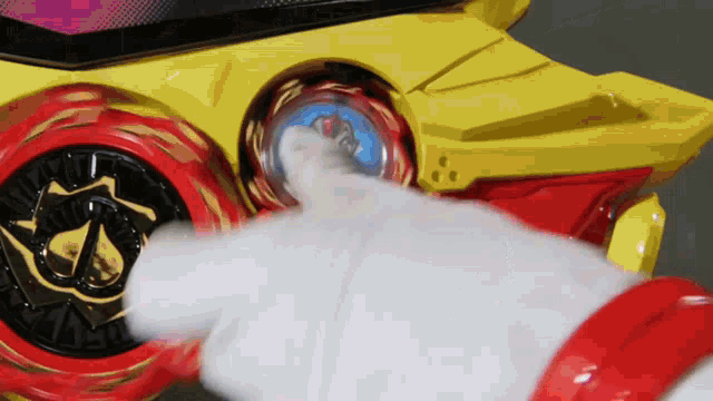 a person in a white glove is pressing a button on a toy