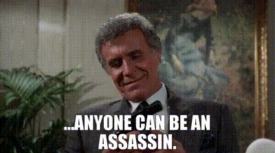 a man in a suit and tie is holding a gun and says `` anyone can be an assassin '' .