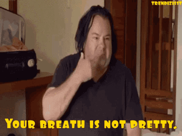 a man says " your breath is not pretty " in front of a suitcase