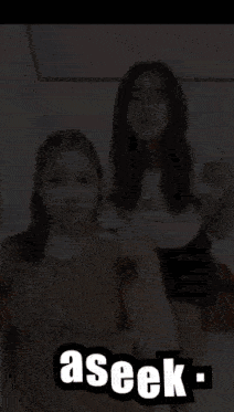 two girls are standing next to each other with the word aseek on the bottom right