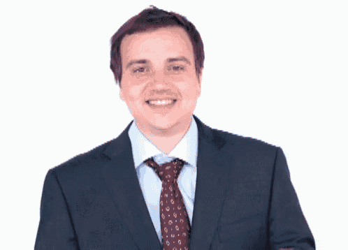 a man in a suit and tie points to the camera