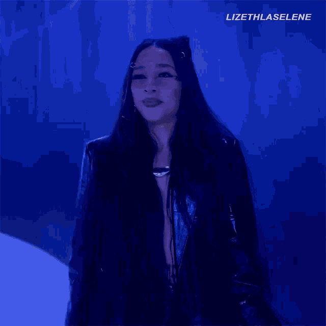 a woman with long hair is wearing a black jacket