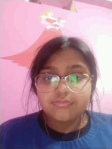 a girl wearing glasses is taking a selfie with a pink background