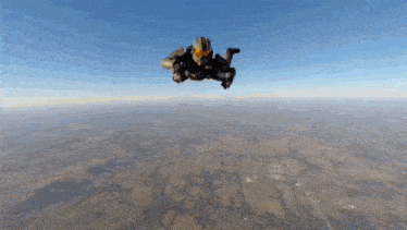 a man is flying through the air with a helmet on