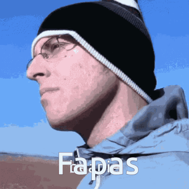 a man wearing a black hat and a blue jacket has the word fapias written on his face