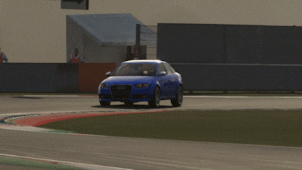 a blue audi car is driving on a track