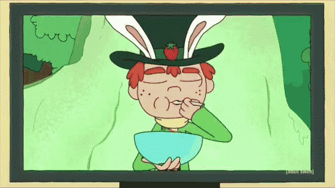 a tv screen shows a cartoon of a boy wearing a bunny hat eating cereal