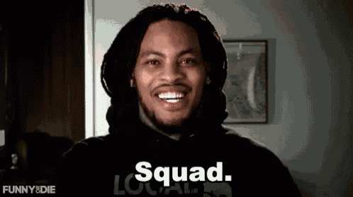 a man with dreadlocks is smiling and wearing a hoodie that says squad .