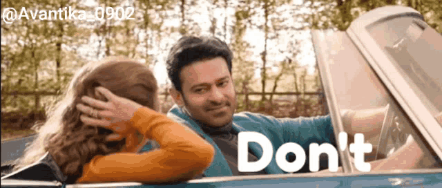 a man and a woman in a car with the word do n't in the corner