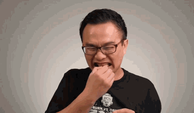 a man wearing glasses and a black shirt that says burn vs. obey