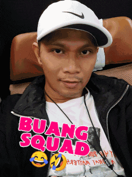 a man wearing a nike hat and a shirt that says " buang squad "