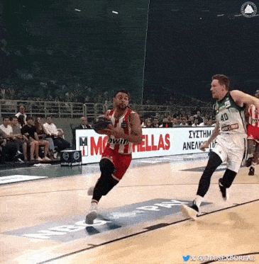a basketball game is being played in front of a sign that says " hellas "