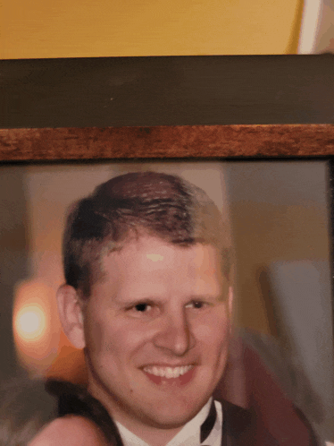 a picture of a man in a tuxedo is framed