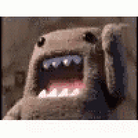 a close up of a stuffed animal with its mouth open and teeth .