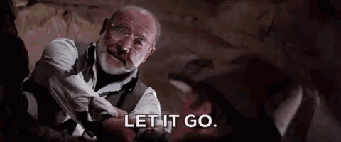 an older man with glasses and a beard is talking to another man .
