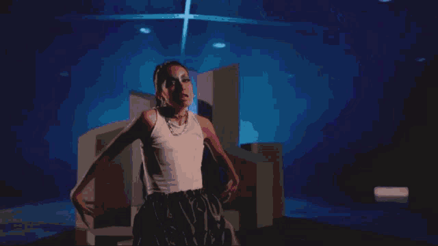 a pixelated image of a woman in a white tank top dancing