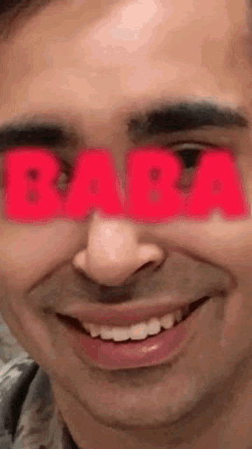 a close up of a man 's face with the word baba in red letters
