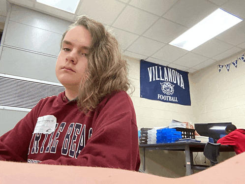 a girl wearing a red villanova football sweatshirt