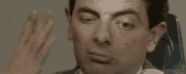 a close up of mr bean making a funny face .