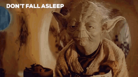 yoda from star wars sitting at a table with a cup of coffee