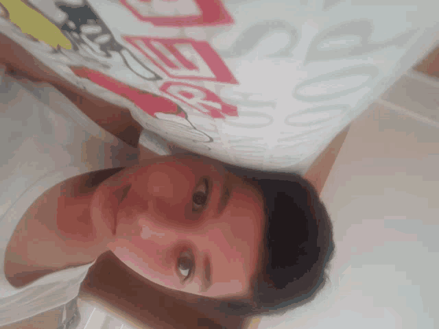 a person laying on a bed with a pillow that says " good " on it