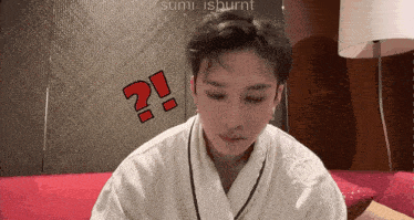a man wearing a white robe has a red question mark on his face