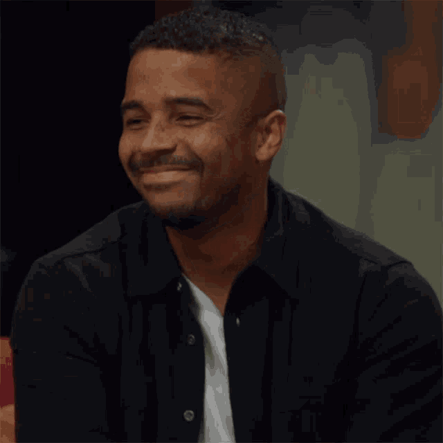 a man says " i 'm so glad to be here " in front of him