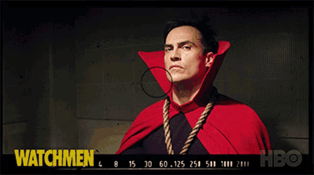 a man in a red cape is pointing at the camera with the words watchmen behind him