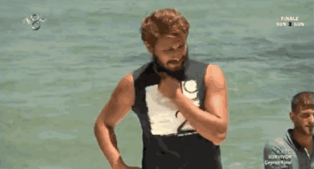 a man in a black tank top with the number 19 on it