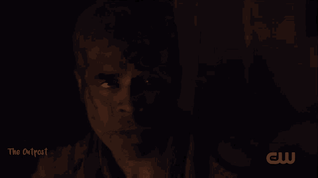 a cw logo can be seen in the corner of a dark scene