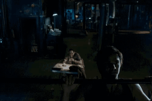 a man is doing a pull up in the dark