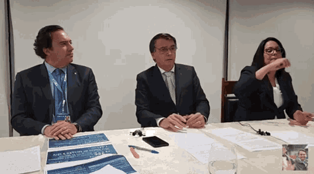 a man in a suit has a lanyard around his neck that says ' oecd '