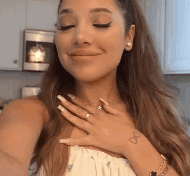 a woman with a tattoo on her wrist that says infinity