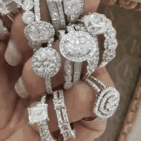 a person is holding a stack of diamonds in their hand .