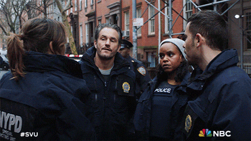 a group of nypd officers standing in a circle
