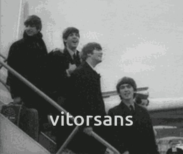 a black and white photo of the beatles boarding an airplane with the words vitorsans above them