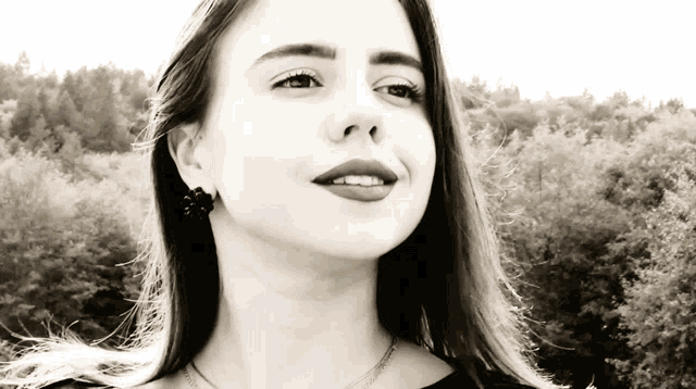 a black and white photo of a woman 's face