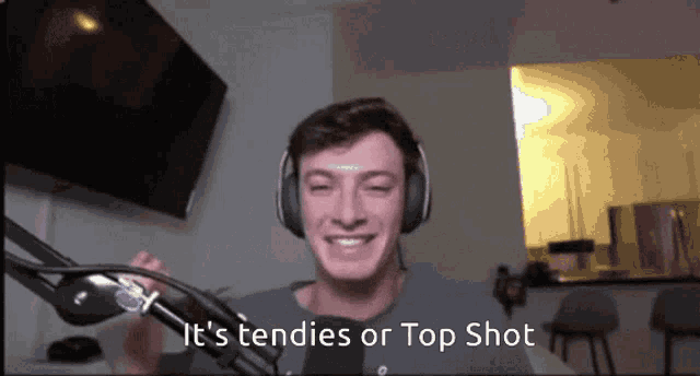 a man wearing headphones says " it 's tendencies or top shot "